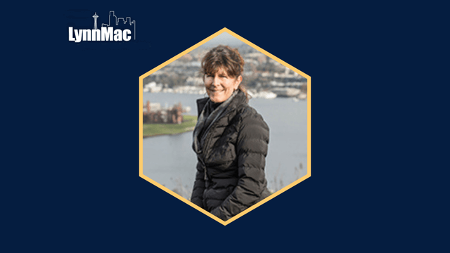 Person in a dark jacket smiling with a scenic waterfront background, framed in a hexagon. Logo text: "LynnMac."
